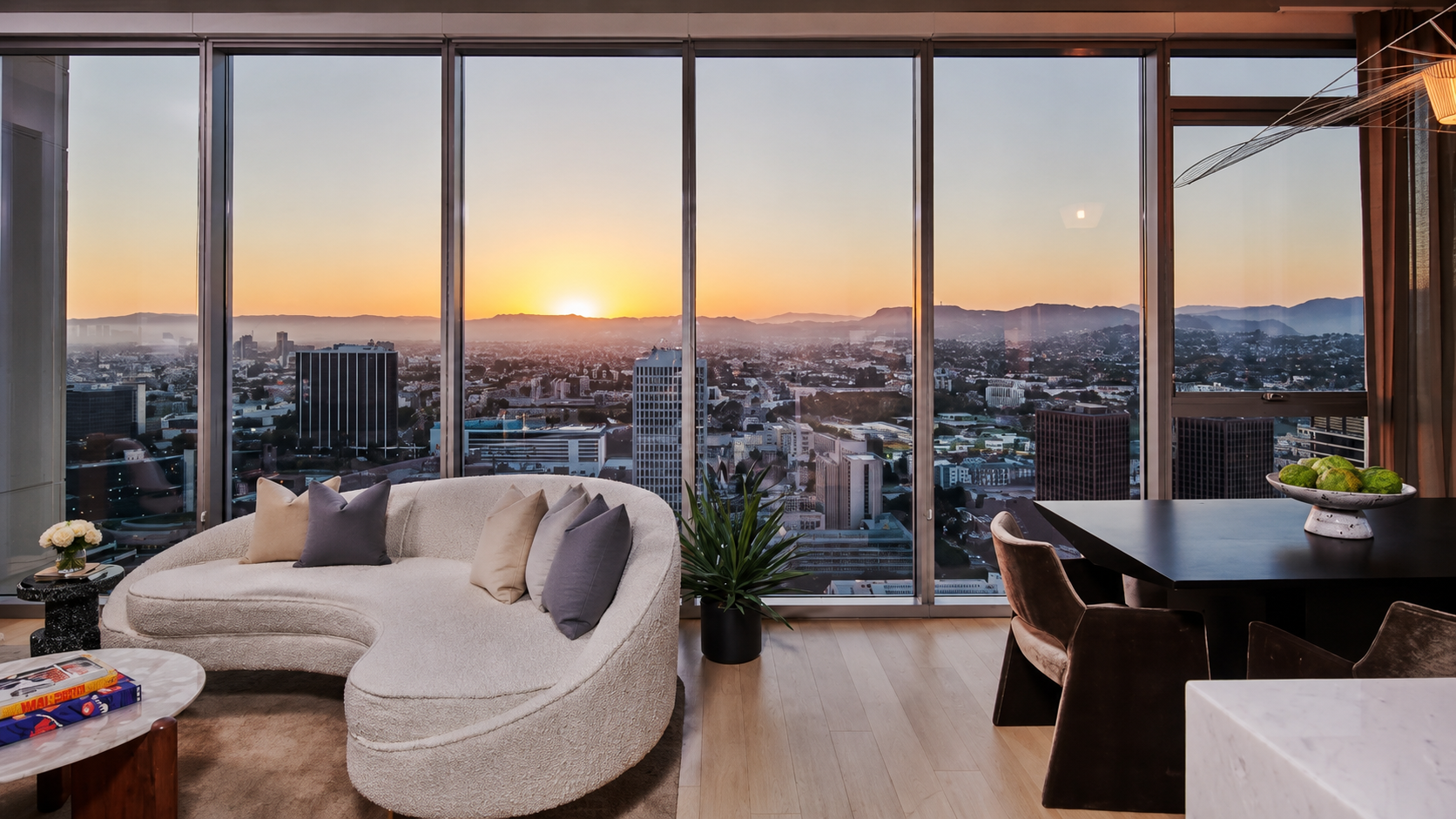 Luxury high-rise living room with LA skyline sunset view